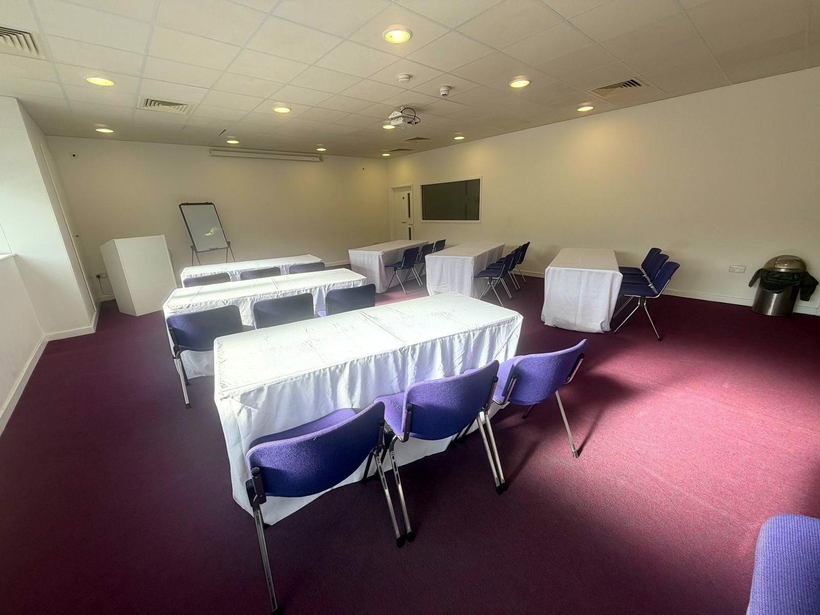 The Meeting Room in classroom layout with flipchart, lectern and wall screen