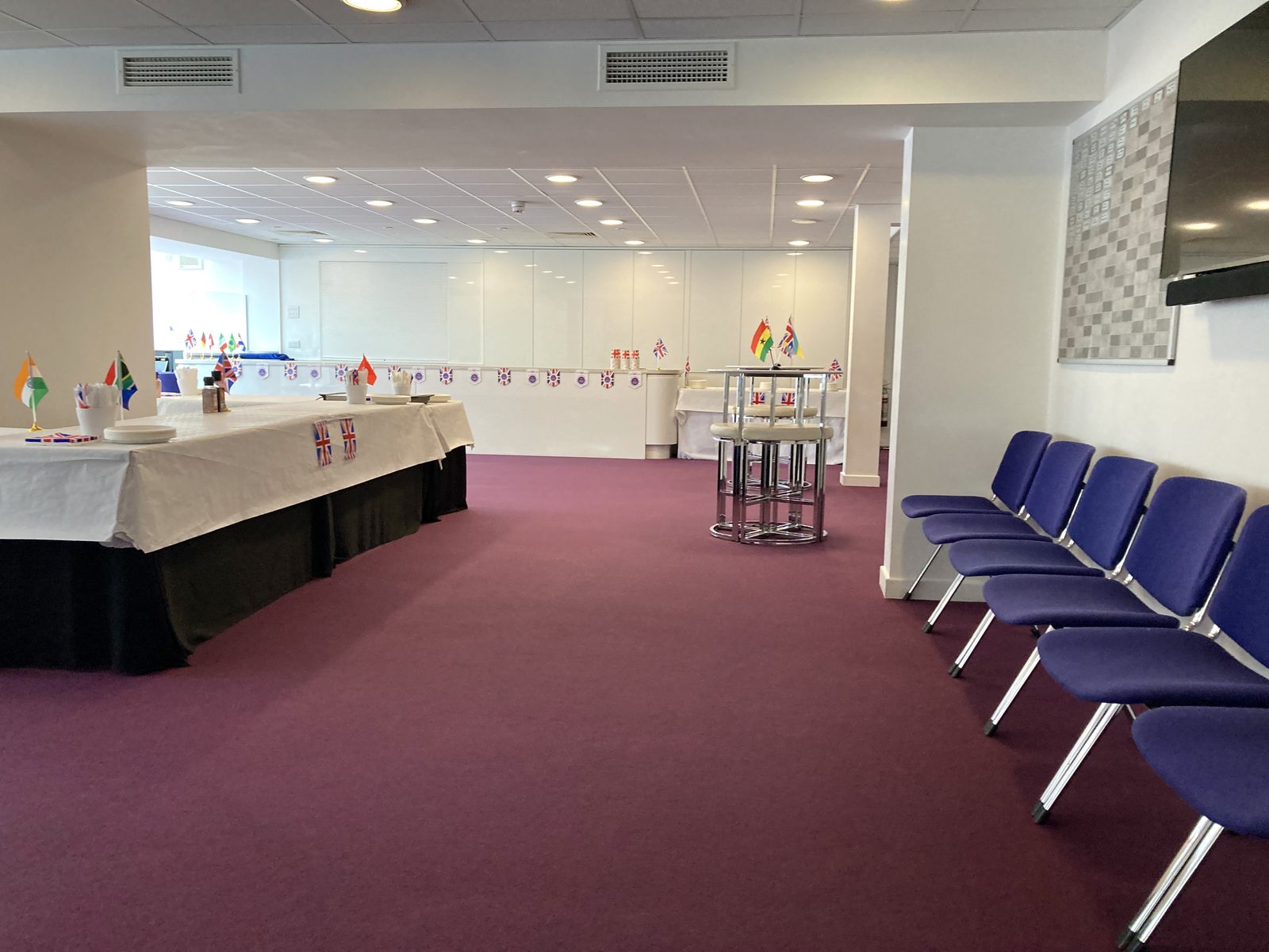Open floor space in The Multifunctional Room with poseur tables and seating